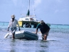Xcalak, Mexico, Xpat, Richard pulling the boat to shore after Hurricane Mitch grounded her. He was headed to Belize when hurricane struck.