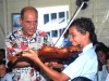 An long-time expat (Harvard grad) living in Placencia, Belize for 20 years, brings in musicians to perform for local children