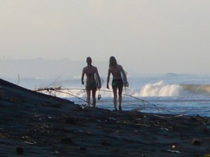 surfers head for the waves at Balian Beach, Bali, Indonesia